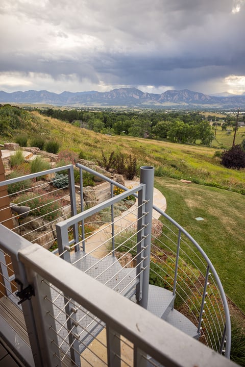 Residential landscape design back of house metal steps view 