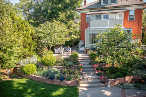 Residential landscape design clients sitting on tiered front patio