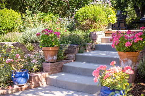 Residential landscape design with retaining wall steps and landscape beds